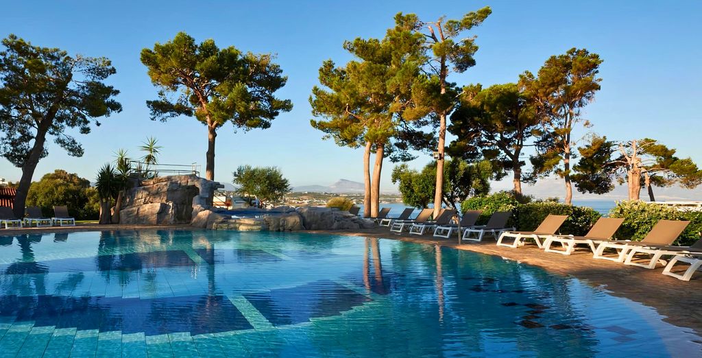 Piscine à débordement bordée de pins, au-dessus de la mer à Terrasini
